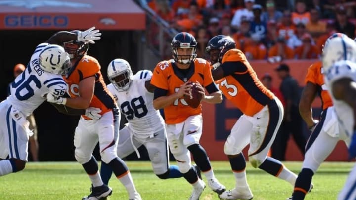Sep 18, 2016; Denver, CO, USA; Denver Broncos offensive tackle Russell Okung (73) and Denver Broncos offensive guard Michael Schofield (79) pass block on Indianapolis Colts linebacker Akeem Ayers (56) and outside linebacker Robert Mathis (98) as quarterback Trevor Siemian (13) scrambles with the ball in the second half at Sports Authority Field at Mile High. Mandatory Credit: Ron Chenoy-USA TODAY Sports