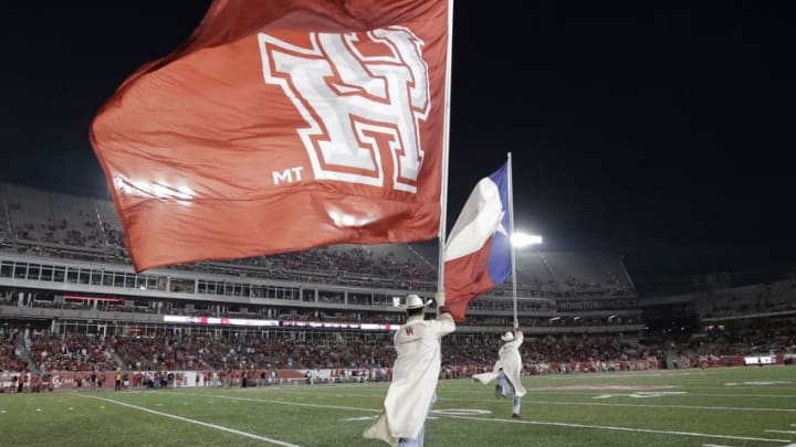 Oct 8, 2015; Houston, TX, USA; University of Houston Cougars Frontiersmen run with the Texas state flag and the U of H flag after a Cougar touchdown against the Southern Methodist University Mustangs at TDECU Stadium. Mandatory Credit: Erich Schlegel-USA TODAY Sports