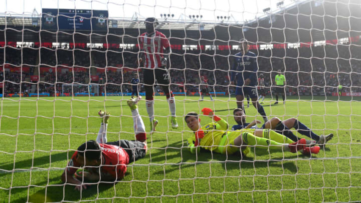 SOUTHAMPTON, ENGLAND - OCTOBER 16: Mohamed Elyounoussi of Southampton ends up in the goal after missing a shot watched on by Illan Meslier of Leeds United during the Premier League match between Southampton and Leeds United at St Mary's Stadium on October 16, 2021 in Southampton, England. (Photo by Alex Davidson/Getty Images)