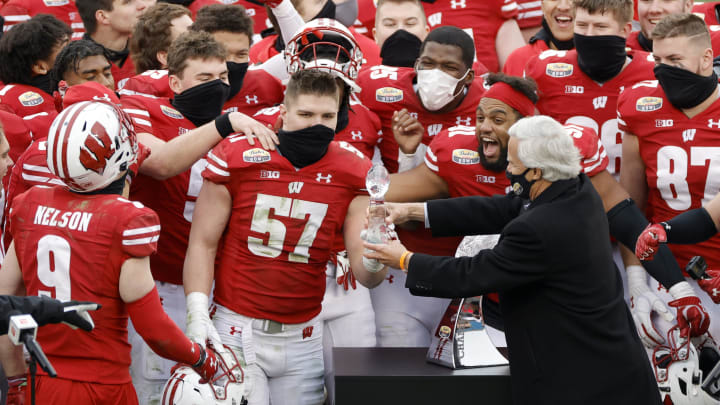 CHARLOTTE, NORTH CAROLINA – DECEMBER 30: Linebacker Jack Sanborn #57 of the Wisconsin Badgers is presented the MVP award of the Duke’s Mayo Bowl against the Wake Forest Demon Deacons at Bank of America Stadium on December 30, 2020 in Charlotte, North Carolina. (Photo by Jared C. Tilton/Getty Images)