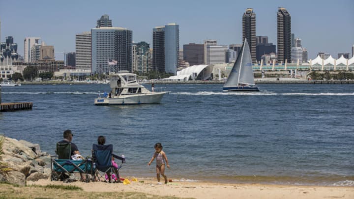 SAN DIEGO, CALIFORNIA - AUGUST 07: A family sits on the beach with a view of the San Diego Symphony's new permanent outdoor venue, the Rady Shell at Jacobs Park on August 07, 2021 in San Diego, California. (Photo by Daniel Knighton/Getty Images)