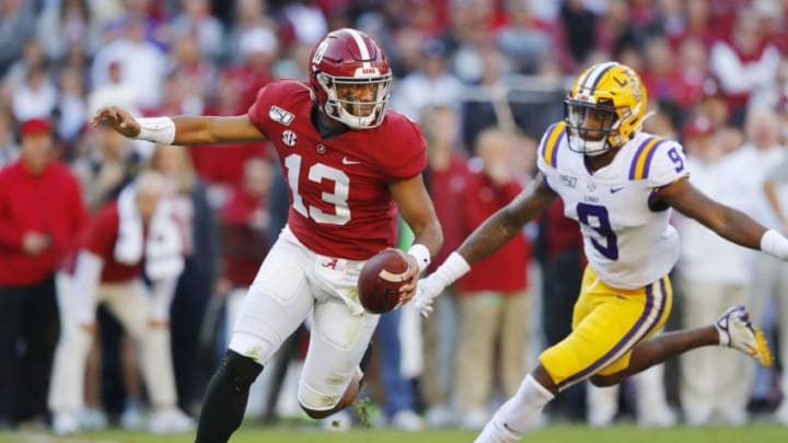 TUSCALOOSA, ALABAMA - NOVEMBER 09: Tua Tagovailoa #13 of the Alabama Crimson Tide attempts to escape pressure from Marcel Brooks #9 of the LSU Tigers during the first half in the game at Bryant-Denny Stadium on November 09, 2019 in Tuscaloosa, Alabama. (Photo by Kevin C. Cox/Getty Images)
