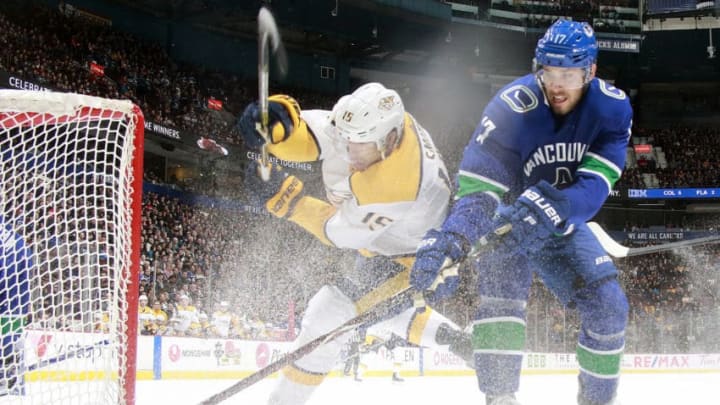 VANCOUVER, BC - DECEMBER 6: Craig Smith #15 of the Nashville Predators checks Josh Leivo #17 of the Vancouver Canucks during their NHL game at Rogers Arena December 6, 2018 in Vancouver, British Columbia, Canada. Vancouver won 5-3. (Photo by Jeff Vinnick/NHLI via Getty Images)