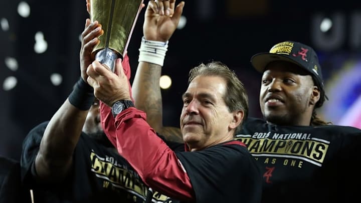 Jan 11, 2016; Glendale, AZ, USA; Alabama Crimson Tide head coach Nick Saban and running back Derrick Henry (right) hoist the national championship trophy after defeating the Clemson Tigers in the 2016 CFP National Championship at University of Phoenix Stadium. Mandatory Credit: Mark J. Rebilas-USA TODAY Sports