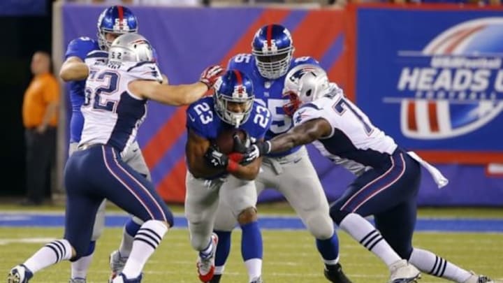 Aug 28, 2014; East Rutherford, NJ, USA; New England Patriots linebacker James Morris (52) and offensive tackle Cameron Fleming (71) close in on New York Giants running back Rashad Jennings (23) during the first half at MetLife Stadium. Mandatory Credit: Jim O Aug 28, 2014; East Rutherford, NJ, USA; New England Patriots linebacker James Morris (52) and offensive tackle Cameron Fleming (71) close in on New York Giants running back Rashad Jennings (23) during the first half at MetLife Stadium. Mandatory Credit: Jim O