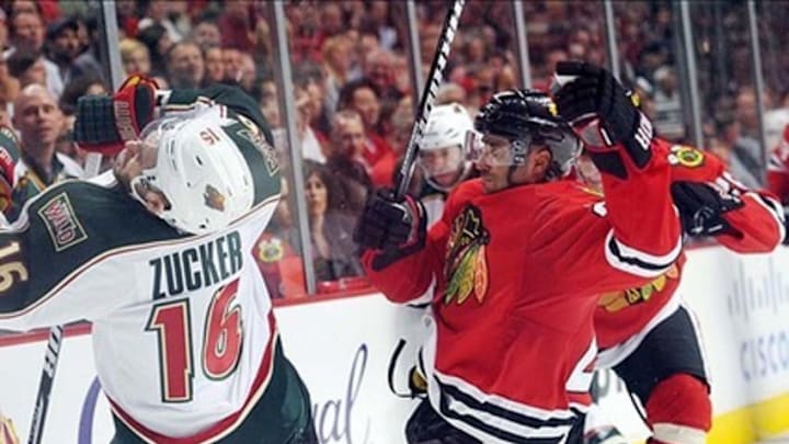 Apr 30, 2013; Chicago, IL, USA; Minnesota Wild left wing Jason Zucker (16) is hit by Chicago Blackhawks defenseman Johnny Oduya (27) during overtime in game one of the first round of the 2013 Stanley Cup playoffs at the United Center. The Blackhawks beat the Wild 2-1 in overtime. Mandatory Credit: Rob Grabowski-USA TODAY Sports