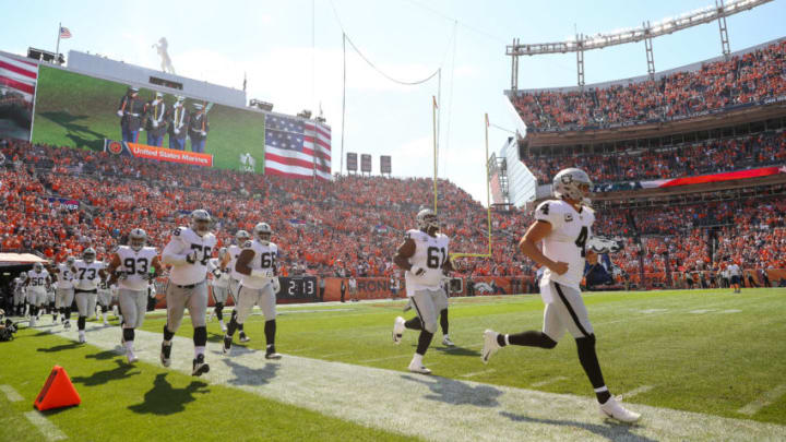 DENVER, CO - SEPTEMBER 16: Oakland Raiders players are led onto the field by Derek Carr #4 before a game against the Denver Broncos at Broncos Stadium at Mile High on September 16, 2018 in Denver, Colorado. (Photo by Matthew Stockman/Getty Images)