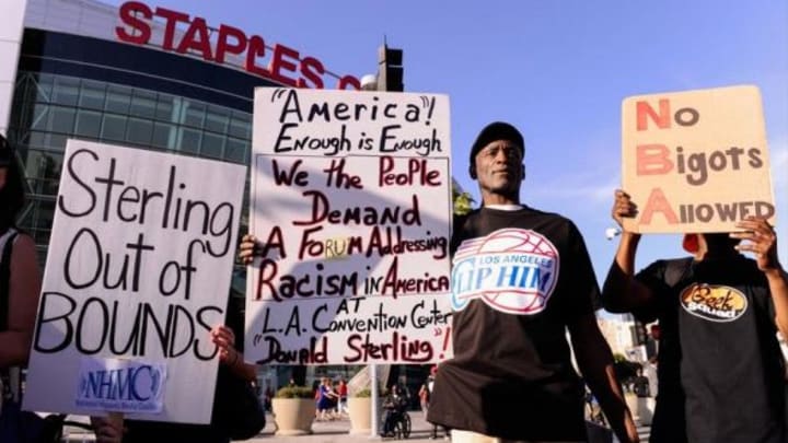Apr 29, 2014; Los Angeles, CA, USA; Morris Griffin, of Los Angeles (center), at a demonstration in front of Staples Center asking for the sale of the Clippers. The NBA banned Clipper owner Donald Sterling for life after it was confirmed that he made racist statements recorded by a female friend.The Clippers and Warrior play game five of the first round of the 2014 NBA Playoffs at Staples Center. Mandatory Credit: Robert Hanashiro-USA TODAY Sports
