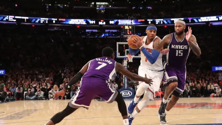 Dec 4, 2016; New York, NY, USA; New York Knicks forward Carmelo Anthony (7) drives between Sacramento Kings guard Darren Collison (7) and center DeMarcus Cousins (15) during the fourth quarter at Madison Square Garden. New York Knicks won 106-98. Mandatory Credit: Anthony Gruppuso-USA TODAY Sports