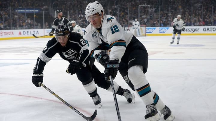 Apr 14, 2016; Los Angeles, CA, USA; San Jose Sharks center Patrick Marleau (12) and Los Angeles Kings defenseman Alec Martinez (27) chase down the puck the first period of the game one of the first round of the 2016 Stanley Cup Playoffs at Staples Center. Mandatory Credit: Jayne Kamin-Oncea-USA TODAY Sports