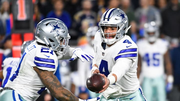 LOS ANGELES, CA - JANUARY 12: Quarterback Dak Prescott #4 of the Dallas Cowboys hands off to running back Ezekiel Elliott #21 in the first quarter against the Los Angeles Rams in the NFC Divisional Round playoff game at Los Angeles Memorial Coliseum on January 12, 2019 in Los Angeles, California. (Photo by Kevork Djansezian/Getty Images)