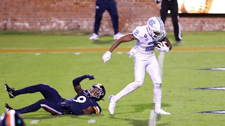 CHARLOTTESVILLE, VA – OCTOBER 31: Dyami Brown #2 of the North Carolina Tar Heels scores a touchdown beyond the reach of Coen King #9 of the Virginia Cavaliers in the second half during a game at Scott Stadium on October 31, 2020 in Charlottesville, Virginia. (Photo by Ryan M. Kelly/Getty Images)