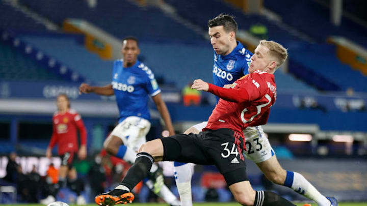LIVERPOOL, ENGLAND - DECEMBER 23: Donny van de Beek of Manchester United stretches for the ball under pressure from Seamus Coleman of Everton during the Carabao Cup Quarter Final match between Everton and Manchester United at Goodison Park on December 23, 2020 in Liverpool, England. A limited number of fans (2000) are welcomed back to stadiums to watch elite football across England. This was following easing of restrictions on spectators in tiers one and two areas only (Photo by Clive Brunskill/Getty Images)