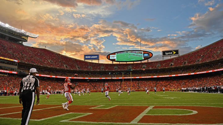 Damien Williams catches a kickoff in the Chiefs' end zone with the Arrowhead Stadium and the sky in the background.