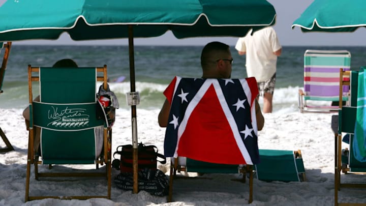DESTIN, FL - JULY 3: People sit at the beach July 3, 2005 in Destin, Florida. Florida has experienced a recent spate of shark attacks, with three in the last week alone. An Austrian tourist was bit on the ankle July 1, while last Monday, June 27, a 16-year-old boy lost his leg not far from the area where a 14-year-old girl was killed the previous Saturday, June 25. (Photo by Spencer Platt/Getty Images)