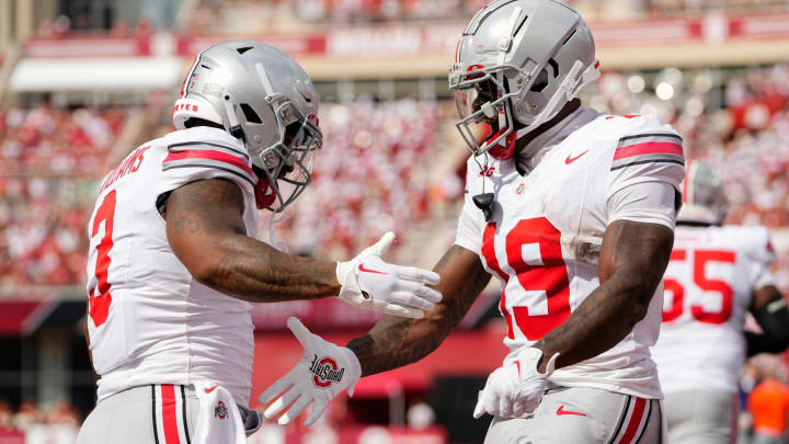 Sep 2, 2023; Bloomington, Indiana, USA; Ohio State Buckeyes running back Chip Trayanum (19) celebrates a touchdown by running back Miyan Williams (3) during the NCAA football game at Indiana University Memorial Stadium. Ohio State won 23-3.