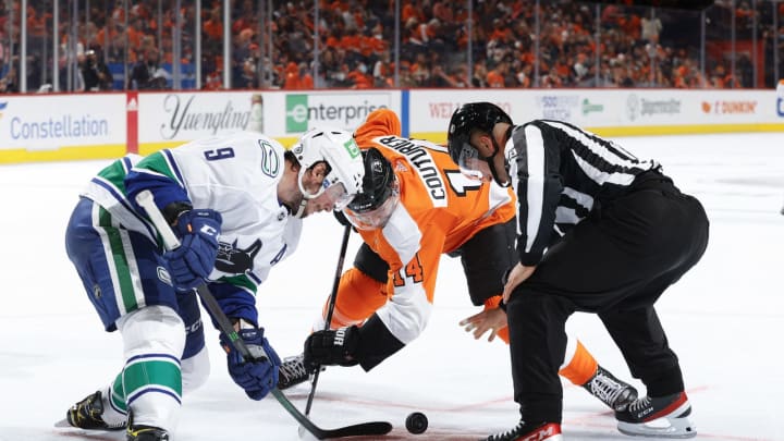 PHILADELPHIA, PENNSYLVANIA – OCTOBER 15: J.T. Miller #9 of the Vancouver Canucks and Sean Couturier #14 of the Philadelphia Flyers faceoff during the second period at Wells Fargo Center on October 15, 2021 in Philadelphia, Pennsylvania. (Photo by Tim Nwachukwu/Getty Images)