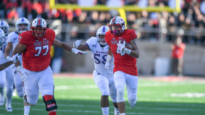 LUBBOCK, TX - OCTOBER 20: Antoine Wesley #4 of the Texas Tech Red Raiders makes the catch and breaks way from the Kansas Jayhawks defense during the second half of the game on October 20, 2018 at Jones AT&T Stadium in Lubbock, Texas. Texas Tech defeated Kansas 48-16. (Photo by John Weast/Getty Images)