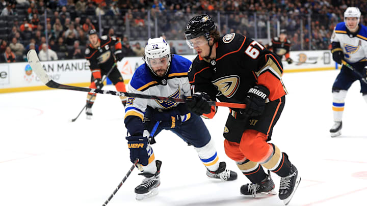 ANAHEIM, CALIFORNIA – MARCH 11: Rickard Rakell #67 of the Anaheim Ducks battles Justin Faulk #72 of the St. Louis Blues for a loose puck during the second period of a game at Honda Center on March 11, 2020 in Anaheim, California. (Photo by Sean M. Haffey/Getty Images)