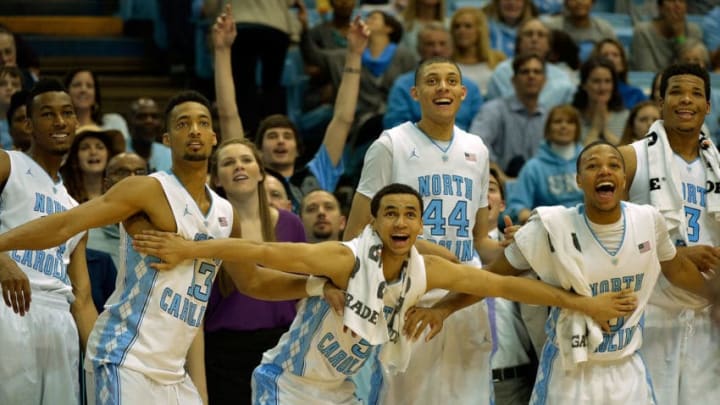 CHAPEL HILL, NC - DECEMBER 27: (L-R) Desmond Hubert #14, J.P. Tokoto #13, Marcus Paige #5, Justin Jackson #44, Nate Britt #0 and Kennedy Meeks #3 of the North Carolina Tar Heels cheer on the reserves during the final minute of a win over the UAB Blazers during their game at the Dean Smith Center on December 27, 2014 in Chapel Hill, North Carolina. North Carolina won 89-58. (Photo by Grant Halverson/Getty Images)