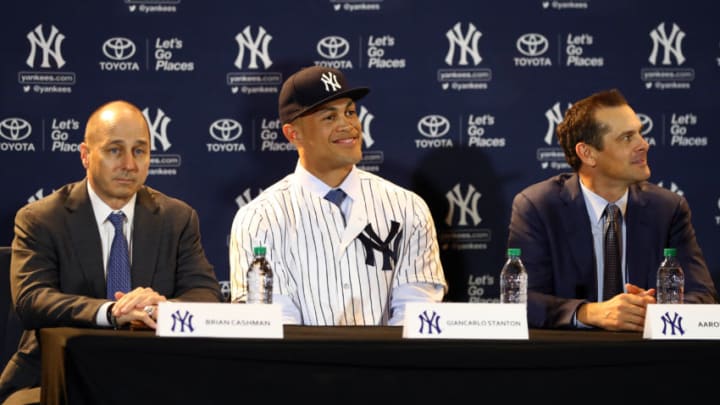ORLANDO, FL - DECEMBER 11: General Manager Brian Cashman, Giancarlo Stanton and Manager Aaron Boone are seen during a press conference where Stanton is introduced as a member of the New York Yankees at the 2017 Winter Meetings at the Walt Disney World Swan and Dolphin Resort on Monday, December 11, 2017 in Orlando, Florida. (Photo by Alex Trautwig/MLB Photos via Getty Images)