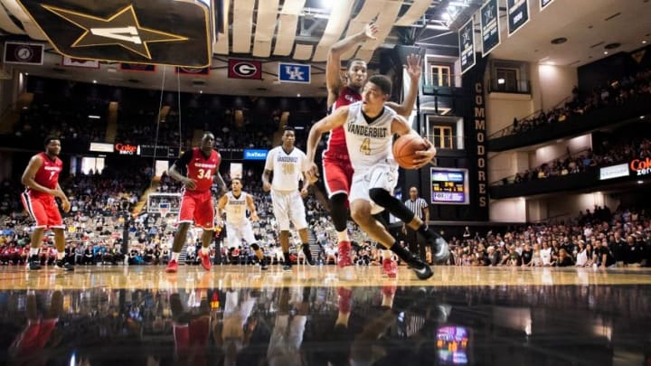 Feb 20, 2016; Nashville, TN, USA; Vanderbilt Commodores guard Wade Baldwin IV (4) drives the ball away from Georgia Bulldogs guard Charles Mann (4) during the second half at Memorial Gym. Vanderbilt Commodores won 80-67. Mandatory Credit: Joshua Lindsey-USA TODAY Sports