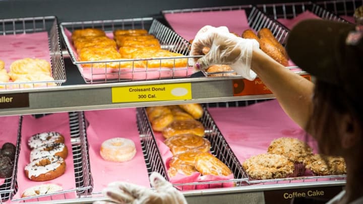 NEW YORK, NY - NOVEMBER 03: A Dunkin' Donuts employee places a fresh tray of 'croissant doughnuts,' on the shelf on November 3, 2014 in New York City. The pastry, which began selling at Dunkin' Donuts two days ago, is based on baker Dominque Ansel's hybrid pastry, the 'cronut,' which came to popularity in the summer of 2013. (Photo by Andrew Burton/Getty Images) NEW YORK, NY - NOVEMBER 03: A Dunkin' Donuts employee places a fresh tray of 'croissant doughnuts,' on the shelf on November 3, 2014 in New York City. The pastry, which began selling at Dunkin' Donuts two days ago, is based on baker Dominque Ansel's hybrid pastry, the 'cronut,' which came to popularity in the summer of 2013. (Photo by Andrew Burton/Getty Images)