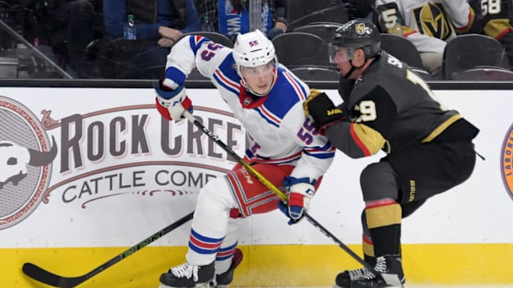 LAS VEGAS, NEVADA - DECEMBER 08: Ryan Lindgren #55 of the New York Rangers skates with the puck under pressure from Reilly Smith #19 of the Vegas Golden Knights in the second period of their game at T-Mobile Arena on December 8, 2019 in Las Vegas, Nevada. The Rangers defeated the Golden Knights 5-0. (Photo by Ethan Miller/Getty Images)