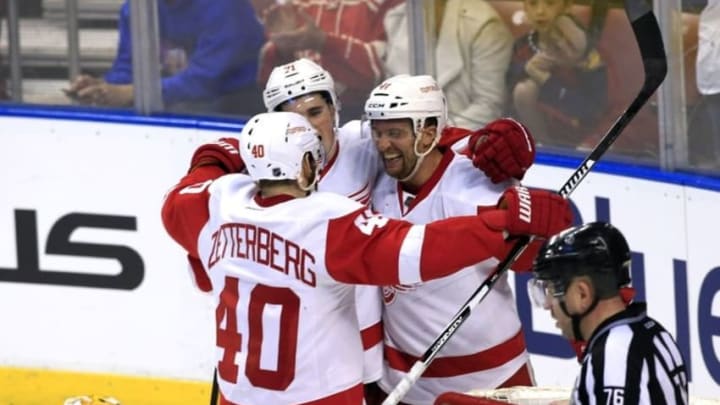 Mar 19, 2016; Sunrise, FL, USA; Detroit Red Wings center Luke Glendening (back) celebrates his goal against Florida Panthers goalie Roberto Luongo (1) with center Dylan Larkin (71) and left wing Henrik Zetterberg (40) in the third period at BB&T Center. The Red Wings won 5-3. Mandatory Credit: Robert Mayer-USA TODAY Sports