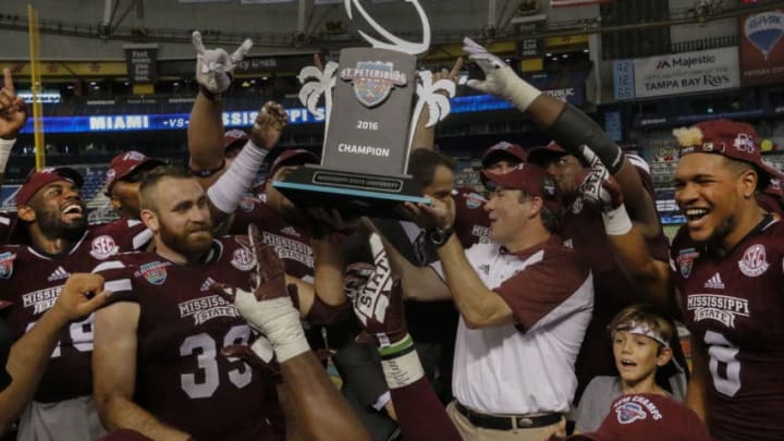 ST. PETERSBURG, FL - DECEMBER 26: The Mississippi State Bulldogs celebrate with the championship trophy after winning 17-16 over the Miami (Oh) Redhawks in the St. Petersburg Bowl at Tropicana Field on December 26, 2016, in St. Petersburg, Florida. (Photo by Joseph Garnett, Jr. /Getty Images)