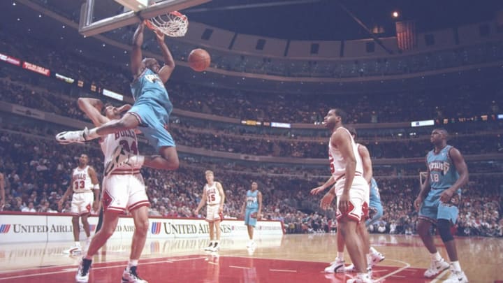 24 Jan 1996: Center Eric Mobley of the Vancouver Grizzlies hangs from the basket during a game against the Chicago Bulls at the United Center in Chicago, Illinois. The Bulls won the game 104-84.