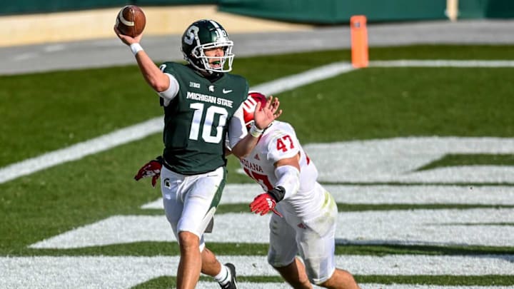 Michigan State’s Payton Thorne, left, throws a screen pass to Elijah Collins as Indiana’s Micah McFadden closes in during the third quarter on Saturday, Nov. 14, 2020, at Spartan Stadium in East Lansing.201114 Msu Indiana 165a