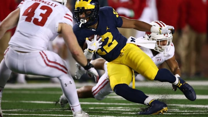 ANN ARBOR, MI - OCTOBER 13: Karan Higdon #22 of the Michigan Wolverines battles for yards between Evan Bondoc #13 and Ryan Connelly #43 of the Wisconsin Badgers on October 13, 2018 at Michigan Stadium in Ann Arbor, Michigan. Michigan won the game 38-13. (Photo by Gregory Shamus/Getty Images)
