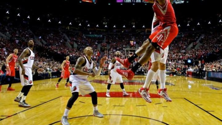 Apr 25, 2014; Portland, OR, USA; Houston Rockets center Dwight Howard (12) dunks over Portland Trail Blazers center Robin Lopez (42) during the second quarter in game three of the first round of the 2014 NBA Playoffs at the Moda Center. Mandatory Credit: Craig Mitchelldyer-USA TODAY Sports