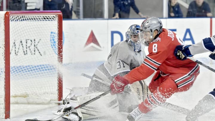 Ohio State's Dakota Joshua (8) knocks the puck in for a goal around Penn State's Peyton Jones at Pegula Ice Arena in University Park, Pa., on Saturday, Jan. 21, 2017. Ohio State won, 6-3. (Abby Drey/Centre Daily Times/TNS via Getty Images)