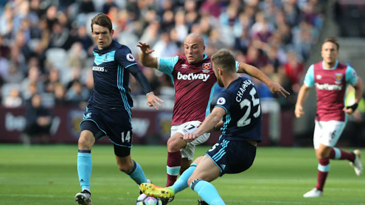 LONDON, ENGLAND - OCTOBER 01: West Ham United's Gokhan Tore is tackled by Middlesbrough's Calum Chambers during the Premier League match between West Ham United and Middlesbrough at Olympic Stadium on October 1, 2016 in London, England. (Photo by Rob Newell - CameraSport/CameraSport via Getty Images)