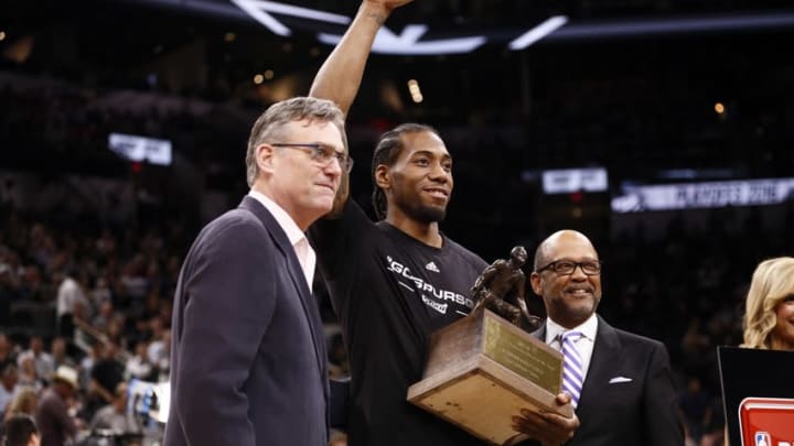 Apr 19, 2016; San Antonio, TX, USA; San Antonio Spurs small forward Kawhi Leonard (2) is presented the Kia Defensive Player of the Year award before game two of the first round of the NBA Playoffs against the Memphis Grizzlies at AT&T Center. Mandatory Credit: Soobum Im-USA TODAY Sports