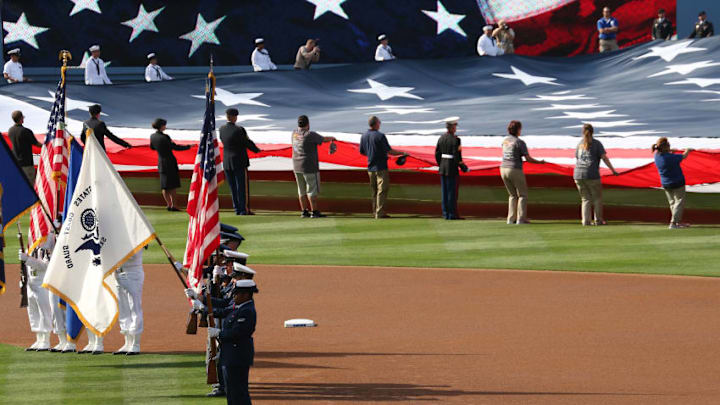 LOS ANGELES, CA - MAY 27: A color guard stands in the infield as a giant American flag is unfurled in the outfield during the national anthem for Memorial Day before the game between the Los Angeles Angels of Anaheim the Los Angeles Dodgers at Dodger Stadium on May 27, 2013 in Los Angeles, California. The Dodgers won 8-7. (Photo by Stephen Dunn/Getty Images)