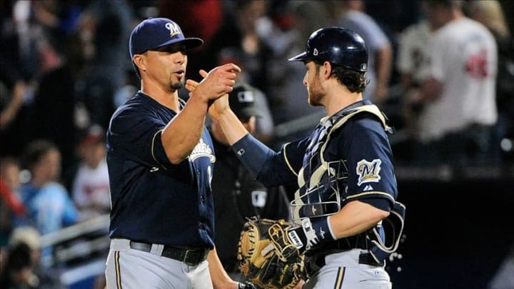 Sep 25, 2013; Atlanta, GA, USA; Milwaukee Brewers starting pitcher Kyle Lohse (26) and catcher Jonathan Lucroy (20) react after defeating the Atlanta Braves at Turner Field. The Brewers defeated the Braves 4-0. Mandatory Credit: Dale Zanine-USA TODAY Sports