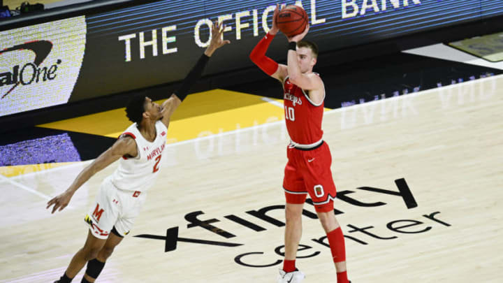 Feb 8, 2021; College Park, Maryland, USA; Ohio State Buckeyes forward Justin Ahrens (10) shoots as Maryland Terrapins guard Aaron Wiggins (2) defends during the first half at Xfinity Center. Mandatory Credit: Tommy Gilligan-USA TODAY Sports