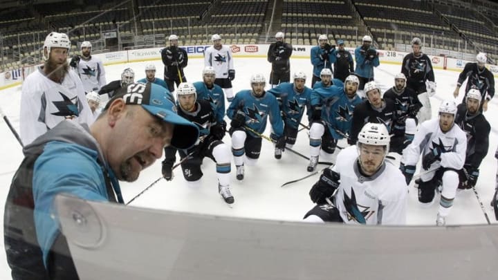 May 29, 2016; Pittsburgh, PA, USA; San Jose Sharks head coach Peter DeBoer (foreground) diagrams on a white board as his team looks on at practice during media day a day prior to game one of the 2016 Stanley Cup Final at the CONSOL Energy Center. Mandatory Credit: Charles LeClaire-USA TODAY Sports