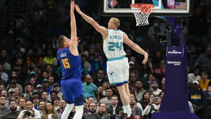 Mar 28, 2022; Charlotte, North Carolina, USA; Charlotte Hornets center Mason Plumlee (24) tries to block Denver Nuggets center Nikola Jokic (15) during the second half at Spectrum Center. Mandatory Credit: Jim Dedmon-USA TODAY Sports