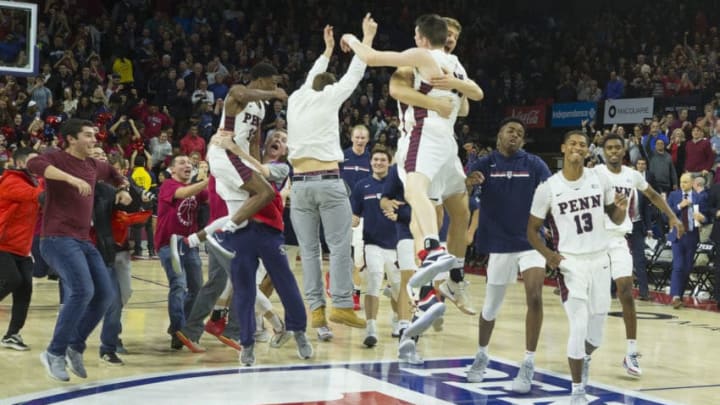 PHILADELPHIA, PA - DECEMBER 11: AJ Brodeur #25, Max Rothschild #0, and Eddie Scott #13 of the Pennsylvania Quakers celebrate their win against the Villanova Wildcats at The Palestra on December 11, 2018 in Philadelphia, Pennsylvania. The Quakers defeated the Wildcats 78-75. (Photo by Mitchell Leff/Getty Images)