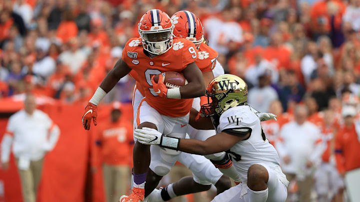 CLEMSON, SOUTH CAROLINA – NOVEMBER 16: Chase Jones #48 of the Wake Forest Demon Deacons tries to stop Travis Etienne #9 of the Clemson Tigers during their game at Memorial Stadium on November 16, 2019 in Clemson, South Carolina. (Photo by Streeter Lecka/Getty Images)