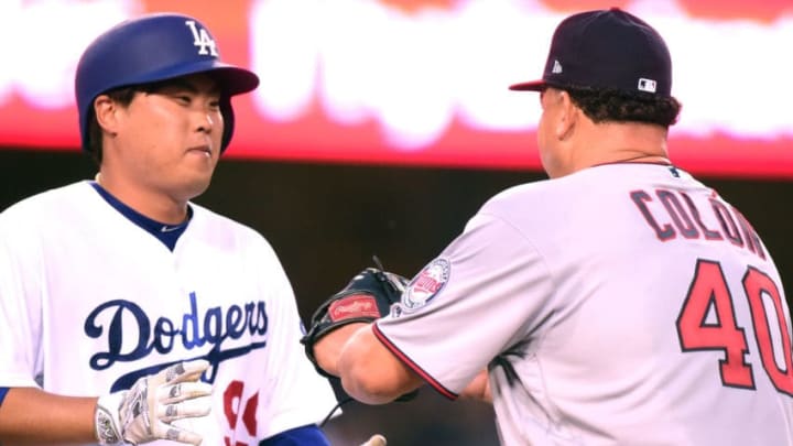 LOS ANGELES, CA - JULY 24: Hyun-Jin Ryu #99 of the Los Angeles Dodgers is tagged out on his bunt by Bartolo Colon #40 of the Minnesota Twins during the third inning at Dodger Stadium on July 24, 2017 in Los Angeles, California. (Photo by Harry How/Getty Images)