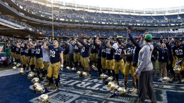 NEW YORK, NY - DECEMBER 28: The Notre Dame Fighting Irish salute fans after winning against the Rutgers Scarlet Knights in the New Era Pinstripe Bowl at Yankee Stadium on December 28, 2013 in the Bronx borough of New York City. (Photo by Jeff Zelevansky/Getty Images)
