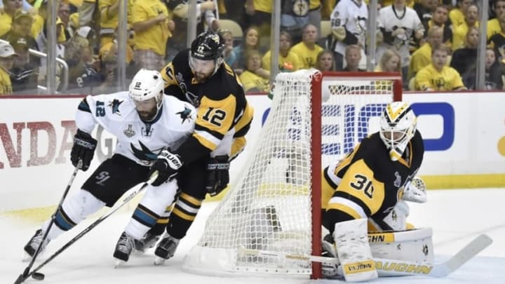 May 30, 2016; Pittsburgh, PA, USA; San Jose Sharks center Patrick Marleau (12) controls the puck behind the net of Pittsburgh Penguins defenseman Ben Lovejoy (12) and goalie Matt Murray (30) in the third period in game one of the 2016 Stanley Cup Final at Consol Energy Center. Mandatory Credit: Don Wright-USA TODAY Sports