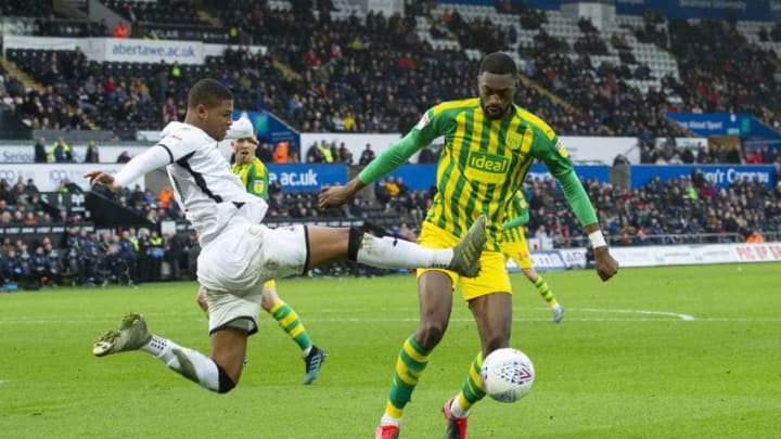 SWANSEA, WALES – MARCH 07: Rhian Brewster of Swansea City battles with Semi Ajayi of West Bromwich Albion during the Sky Bet Championship match between Swansea City and West Bromwich Albion at the Liberty Stadium on March 07, 2020 in Swansea, Wales. (Photo by Athena Pictures/Getty Images)