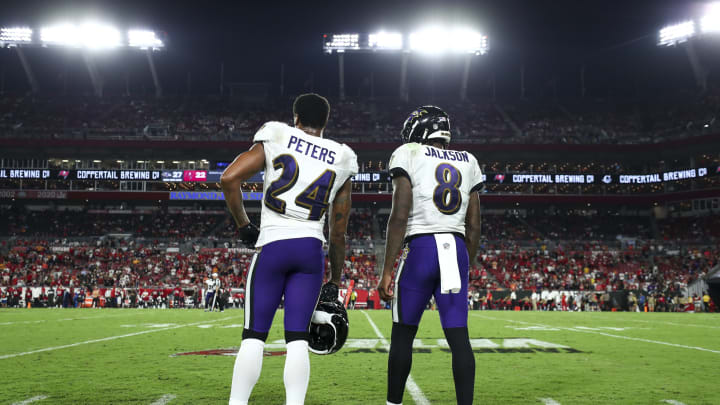 TAMPA, FL – OCTOBER 27: Marcus Peters #24 of the Baltimore Ravens talks with Lamar Jackson #8 on the sidelines during an NFL football game against the Tampa Bay Buccaneers at Raymond James Stadium on October 27, 2022 in Tampa, Florida. (Photo by Kevin Sabitus/Getty Images)
