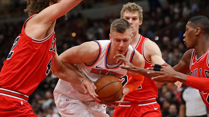 CHICAGO, IL - DECEMBER 27: Kristaps Porzingis #6 of the New York Knicks drives between Robin Lopez #42 (L) and Kris Dunn #32 of the Chicago Bulls at the United Center on December 27, 2017 in Chicago, Illinois. (Photo by Jonathan Daniel/Getty Images)